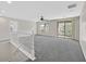 This loft features carpeted floors, a ceiling fan, natural light, and a view of the hills and neighborhood at 65 Pangloss St, Henderson, NV 89002