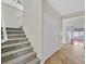 Carpeted stairs in a brightly lit home with tile floors and white walls at 65 Pangloss St, Henderson, NV 89002
