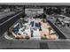 Expansive aerial view showcases the property's layout, pool, solar panels, and convenient access to nearby freeway at 6882 Palmyra Ave, Las Vegas, NV 89146
