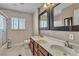 Bathroom with double sinks, framed mirror and walk-in shower at 6882 Palmyra Ave, Las Vegas, NV 89146