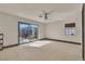 Bedroom featuring white walls, tile floors, large sliding glass doors and window at 6882 Palmyra Ave, Las Vegas, NV 89146
