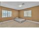 Neutral bedroom with tile flooring and natural light from two windows at 6882 Palmyra Ave, Las Vegas, NV 89146