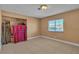 Bedroom featuring light walls, tile floors, large window, and spacious closet at 6882 Palmyra Ave, Las Vegas, NV 89146