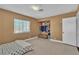 Bedroom featuring neutral paint, tile floors, large window and closet at 6882 Palmyra Ave, Las Vegas, NV 89146