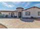 The stone turret is the perfect entryway to this charming home, framed by desert landscaping at 6882 Palmyra Ave, Las Vegas, NV 89146