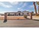 This charming single-story house is accented by a turret entry, desert landscaping, and a circular driveway at 6882 Palmyra Ave, Las Vegas, NV 89146