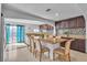 Eat in kitchen featuring a large island and granite counters next to the sliding glass door at 6882 Palmyra Ave, Las Vegas, NV 89146