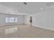 Bright living room with tile flooring, neutral walls, and a view into the open doorway at 6882 Palmyra Ave, Las Vegas, NV 89146