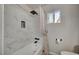 Bathroom featuring a tub with white marble-style tile surround and a window that lets in natural light at 700 Cactus Ln, Las Vegas, NV 89107