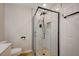 Bathroom featuring a modern glass shower with stone flooring, black trim and fixtures, and built-in shelving at 700 Cactus Ln, Las Vegas, NV 89107