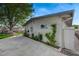 Exterior view of home featuring a concrete driveway, greenery, and a large mature shade tree at 700 Cactus Ln, Las Vegas, NV 89107