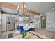 Bright kitchen with stainless steel appliances, a blue island, and a decorative chandelier at 700 Cactus Ln, Las Vegas, NV 89107