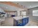 Open kitchen with large island, modern lighting, and decorative wooden beams in an open floorplan at 700 Cactus Ln, Las Vegas, NV 89107