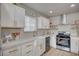 Well-lit kitchen features white cabinetry, stainless steel appliances, and a farmhouse sink at 700 Cactus Ln, Las Vegas, NV 89107