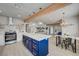 Open kitchen with wooden beam accents, pendant lighting, and a blue island with gold hardware at 700 Cactus Ln, Las Vegas, NV 89107