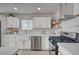 Kitchen featuring white cabinets, stainless steel appliances, and open shelving at 700 Cactus Ln, Las Vegas, NV 89107