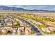 Panoramic aerial view of a suburban community with orderly homes, landscaped streets, and desert mountains in the distance at 7556 Wingspread St, North Las Vegas, NV 89084