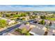 Wide aerial shot showcasing a neatly planned residential area with golf course, tidy streets and houses under a blue, mountainous skyline at 7556 Wingspread St, North Las Vegas, NV 89084