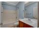 Well-lit bathroom featuring a shower-tub combination and a vanity with a white countertop at 7556 Wingspread St, North Las Vegas, NV 89084