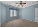 This is a spacious bedroom with a ceiling fan and lots of natural light at 7556 Wingspread St, North Las Vegas, NV 89084