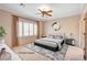 This bedroom features modern decor with a ceiling fan and bright natural light at 7556 Wingspread St, North Las Vegas, NV 89084