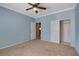 Bedroom with ceiling fan, view to closet, and doorway to another room at 7556 Wingspread St, North Las Vegas, NV 89084