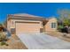 Attractive single-story home with a two-car garage, xeriscaping, and a desert-friendly landscape at 7556 Wingspread St, North Las Vegas, NV 89084