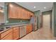 Traditional kitchen with stainless steel appliances, wood cabinetry, and tile floors at 7556 Wingspread St, North Las Vegas, NV 89084