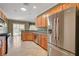 Bright kitchen features stainless steel appliances, granite countertops, and tile flooring at 7556 Wingspread St, North Las Vegas, NV 89084