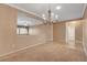 Spacious living room features a modern chandelier and a half wall at 7556 Wingspread St, North Las Vegas, NV 89084