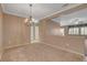 The spacious living room features neutral walls and carpet and offers a seamless transition to other living areas at 7556 Wingspread St, North Las Vegas, NV 89084