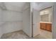 Walk-in closet with open view to bathroom at 7556 Wingspread St, North Las Vegas, NV 89084