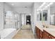 Bright bathroom featuring a separate shower and tub, and a dual sink vanity at 7641 Lani Dawn St, Las Vegas, NV 89149