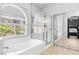 Bright bathroom featuring separate soaking tub and shower with glass enclosure at 7641 Lani Dawn St, Las Vegas, NV 89149