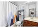 Well-lit bathroom with a mountain-themed shower curtain and a wooden vanity at 7641 Lani Dawn St, Las Vegas, NV 89149