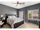 Bedroom with dark wood furniture and large windows for plenty of natural light at 7641 Lani Dawn St, Las Vegas, NV 89149