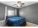 Cozy bedroom features a modern ceiling fan and a comfortable platform bed at 7641 Lani Dawn St, Las Vegas, NV 89149