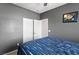Bedroom with neutral gray walls, and a large closet with open doors at 7641 Lani Dawn St, Las Vegas, NV 89149