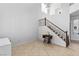 Bright entryway featuring a staircase with wooden banister and decorative table, creating a welcoming atmosphere at 7641 Lani Dawn St, Las Vegas, NV 89149