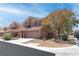 A suburban two-story house features a paved driveway, a two-car garage, and a well-manicured front yard at 7641 Lani Dawn St, Las Vegas, NV 89149