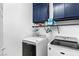 Laundry room with front-loading washer and dryer and blue cabinets above at 7641 Lani Dawn St, Las Vegas, NV 89149