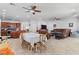 Open-concept floorplan with kitchen island, living room with leather sofa, and dining area perfect for entertaining at 7641 Lani Dawn St, Las Vegas, NV 89149