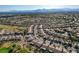 Aerial view of the community with well maintained homes, tree-lined streets, and lots of green space at 7760 Pine Warbler Way, North Las Vegas, NV 89084