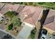 Birds-eye view of a charming home with a well-maintained roof, desert landscape, and attached two-car garage at 7760 Pine Warbler Way, North Las Vegas, NV 89084