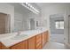 Bathroom with double vanity, ample storage, and access to both bedroom and walk-in closet at 7760 Pine Warbler Way, North Las Vegas, NV 89084