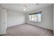 Bright bedroom with neutral carpet, large window, and a ceiling fan at 7760 Pine Warbler Way, North Las Vegas, NV 89084