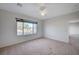 Bright bedroom with neutral carpet, and a large window at 7760 Pine Warbler Way, North Las Vegas, NV 89084