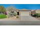 Charming single-story home with well-maintained desert landscaping and a spacious two-car garage at 7760 Pine Warbler Way, North Las Vegas, NV 89084