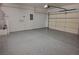 A two car garage with light gray epoxy flooring and a garage door at 7760 Pine Warbler Way, North Las Vegas, NV 89084