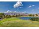 Breathtaking golf course and lake view with mountain backdrop, perfect for scenic relaxation and leisurely recreation at 7760 Pine Warbler Way, North Las Vegas, NV 89084